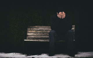 Man sitting bench covering face - andor basch free wallpaper