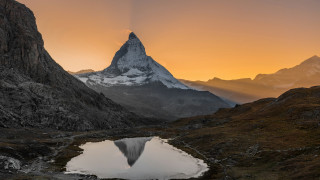 Mountain lake reflection cloudy sunset - a lake in the middle of it free wallpaper