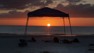 Sunset beach tent people lighthouse - free sunset wallpaper