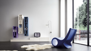 Blue chair white rug bookshelf - a television free wallpaper