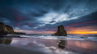 Beach rock formation sunset clouds - a rock formation free wallpaper