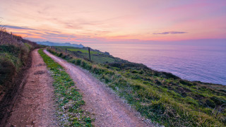 Dirt road hill ocean sunset - in the foreground free wallpaper