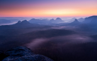 Mountain range foggy valley sunset - a foggy valley below free wallpaper