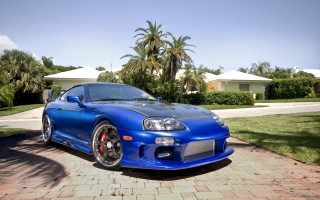 Blue sports car brick driveway - a house free wallpaper