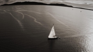 Sailboat mountains ocean clouds blackwhite - a sailboat free wallpaper