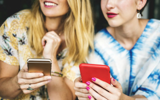Women sitting cell phones together - product photo free wallpaper for desktop