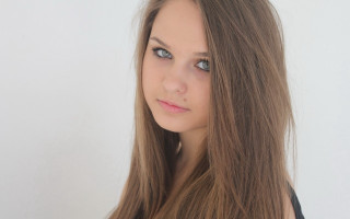 Woman long hair portrait white - a white wall behind her free wallpaper