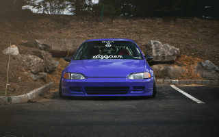 Blue car parked rock wall - a bicycle free wallpaper
