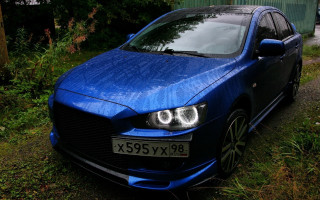 Blue car parked grass road - bush free wallpaper