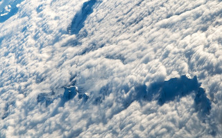 Mountain range airplane wing clouds - an airplane window free wallpaper for desktop