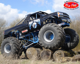 Monster truck jumping logs field - a monster truck free wallpaper