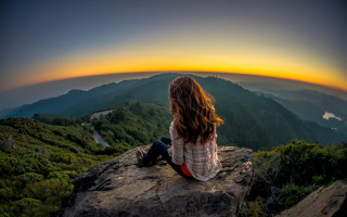 Woman sitting rock sunset valley - a view of a valley free wallpaper