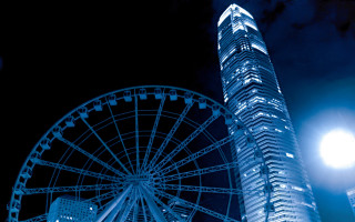 Ferriswheel tallbuilding nightlight fireworks fullmoon - a tall building in the background free wallpaper