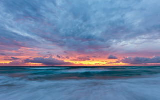 Sunset ocean wave clouds boat - free beach wallpaper
