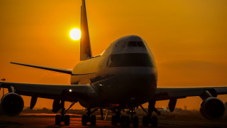 Large jetliner sunset runway backlit - top of an airport runway free wallpaper