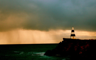 Lighthouse cliff stormy sky lightning - a dark sky in the background free wallpaper for desktop
