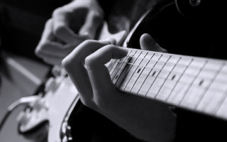 Person playing guitar fingers neck - grunge free wallpaper