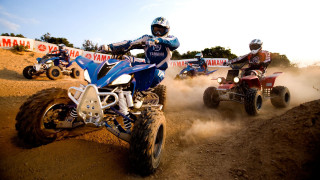 Two people four wheelers dirt - a banner in the background free wallpaper