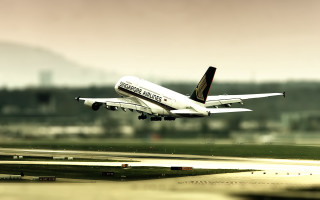Large jet flying over runway - a large passenger free wallpaper