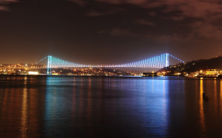 Nighttime bridge city lights water - bruce munro free wallpaper