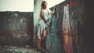 Woman graffiti beach fashion cave - her leg up against the wall free wallpaper
