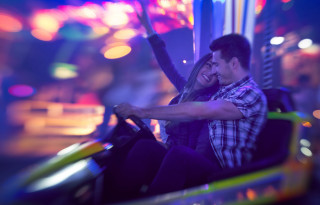 Night rollercoaster neon carnival blur - a man and woman free wallpaper for desktop