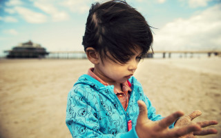 Little girl beach ocean hands - a sandy beach next free wallpaper