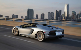 Silver sports car city skyline - a silver sports car free wallpaper