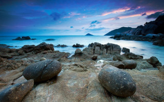 Rocky beach dusk purple sky - a purple sky in the background free wallpaper for desktop