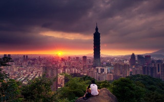 Person sitting rock overlooking city - dai xi free wallpaper