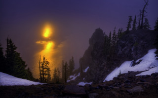 Foggy mountain lake trees mystical - a bright light in the distance free wallpaper