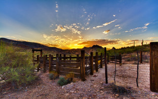Desert fence sunset mountains clouds - art free wallpaper for desktop
