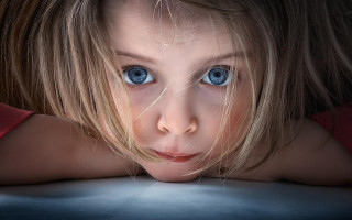 Young girl blue eyes serious 2 - a young girl free wallpaper