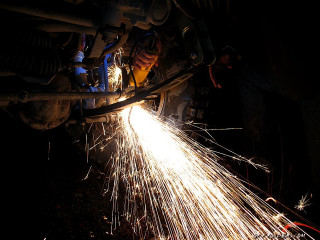 Person welding metal sparks light - evariste vital luminai free wallpaper