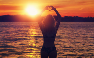 Sunset beach woman bikini silhouette - her arm free wallpaper