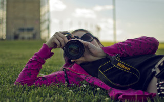 Woman grass camera lens building - a camera len free wallpaper