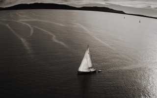 Sailboat mountains beach clouds monochrome - annie leibovitz free wallpaper