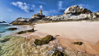 Sandy beach rock formation cloudy - a sandy beach free wallpaper