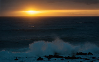 Sunset ocean wave rock person - a sunset over the ocean free wallpaper for desktop