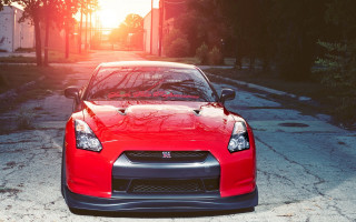 Red sports car sunset photorealistic - the sun shining behind free wallpaper