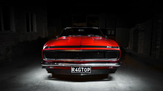 Red car dark garage brick - a license plate free wallpaper