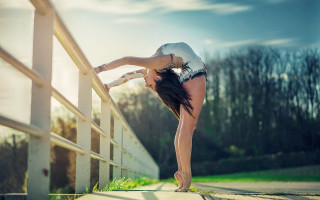 Woman leaning bridge stretching legs - a rail free wallpaper