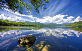 Lake rock mountain clouds sky 2 - a rock in the middle of it free wallpaper