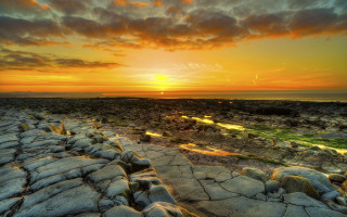 Sunset rocky beach path water - a sunset over a rocky beach free wallpaper