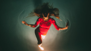 Woman floating water red shirt - floating free wallpaper