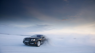 Black car driving snowfield cloudy - a snow free wallpaper for desktop