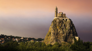 Large rock tower village cloudy - a village free wallpaper