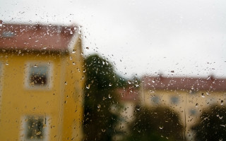 Rainy window yellow building red - a tilt shift photo free wallpaper