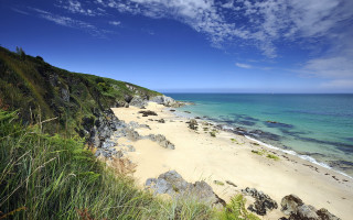 Beach cliff water sky clouds - a cliff and a body of water free wallpaper