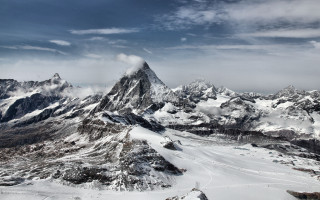 Snowy mountains cloudy horizon beach - a few snow covered mountains free wallpaper